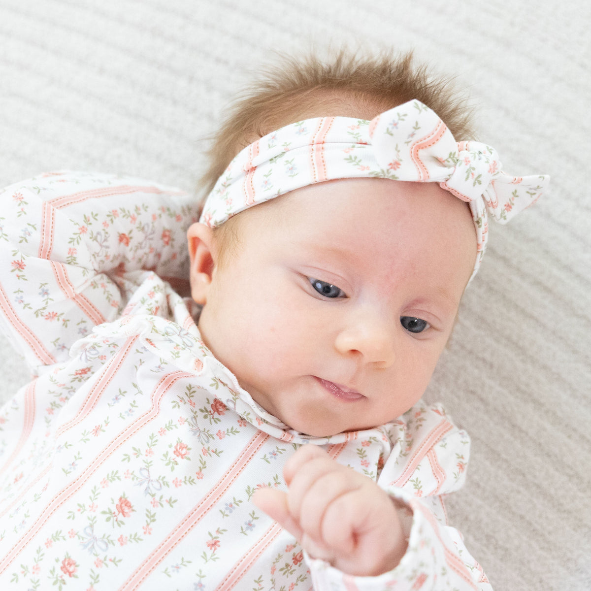 Knot headband in a rosebud stripe pattern with a knotted bow detail at the front.