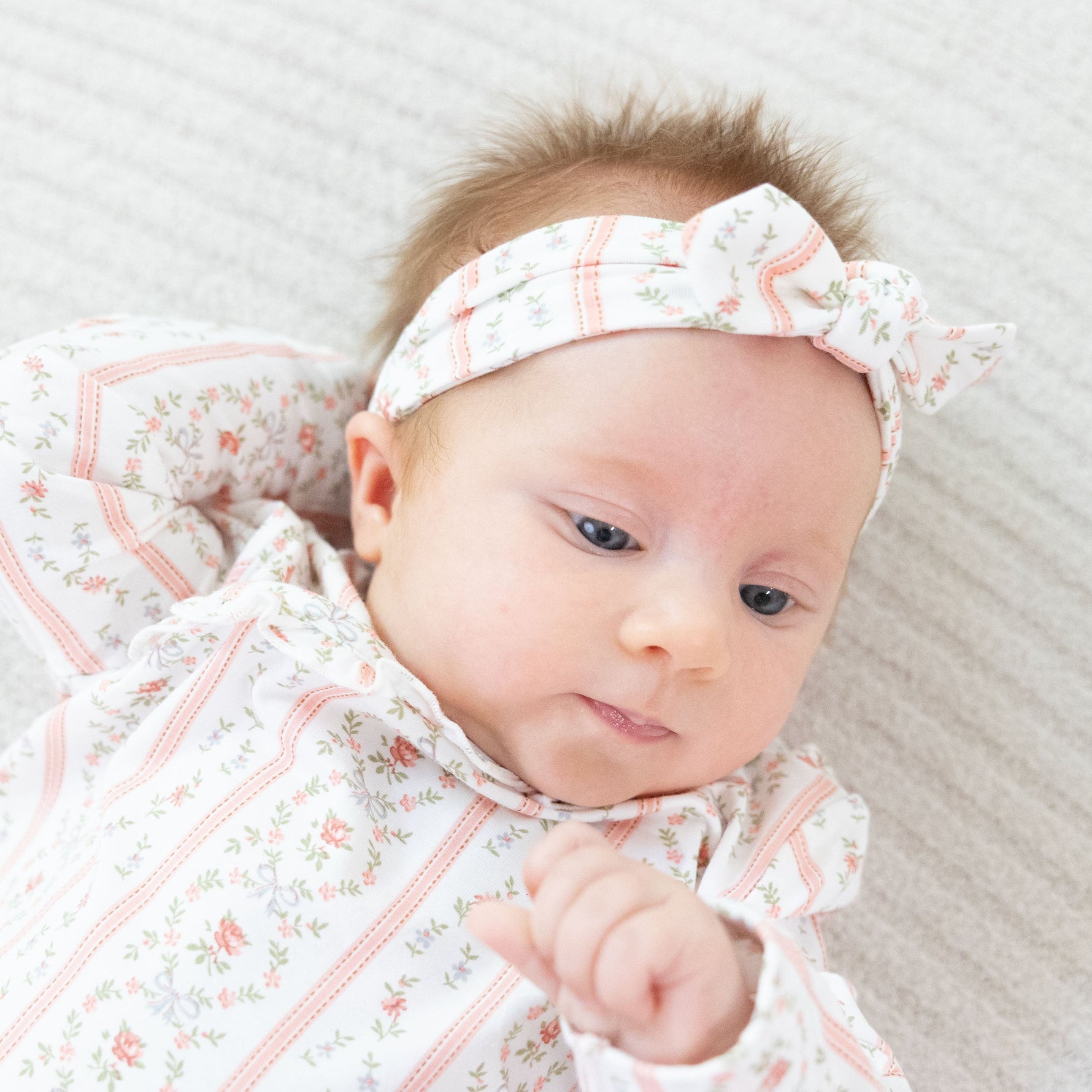 Knot headband in a rosebud stripe pattern with a knotted bow detail at the front.