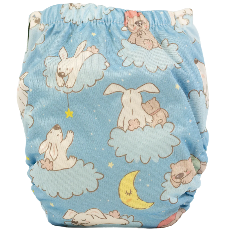 Tiny Tushies Newborn AIO Cloth Diaper with playful animal print on blue background.