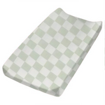 Leaf green and white checkered organic changing pad cover by Little Mae & Co on a changing table