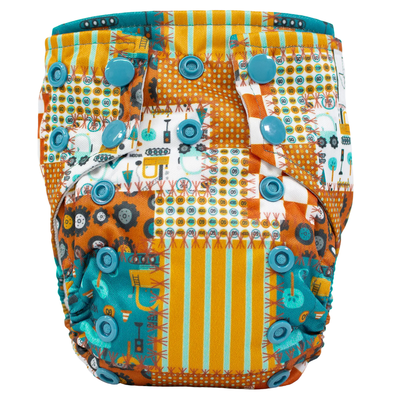Tiny Tushies Newborn AIO Cloth Diaper with colorful patterned design and secure snaps.