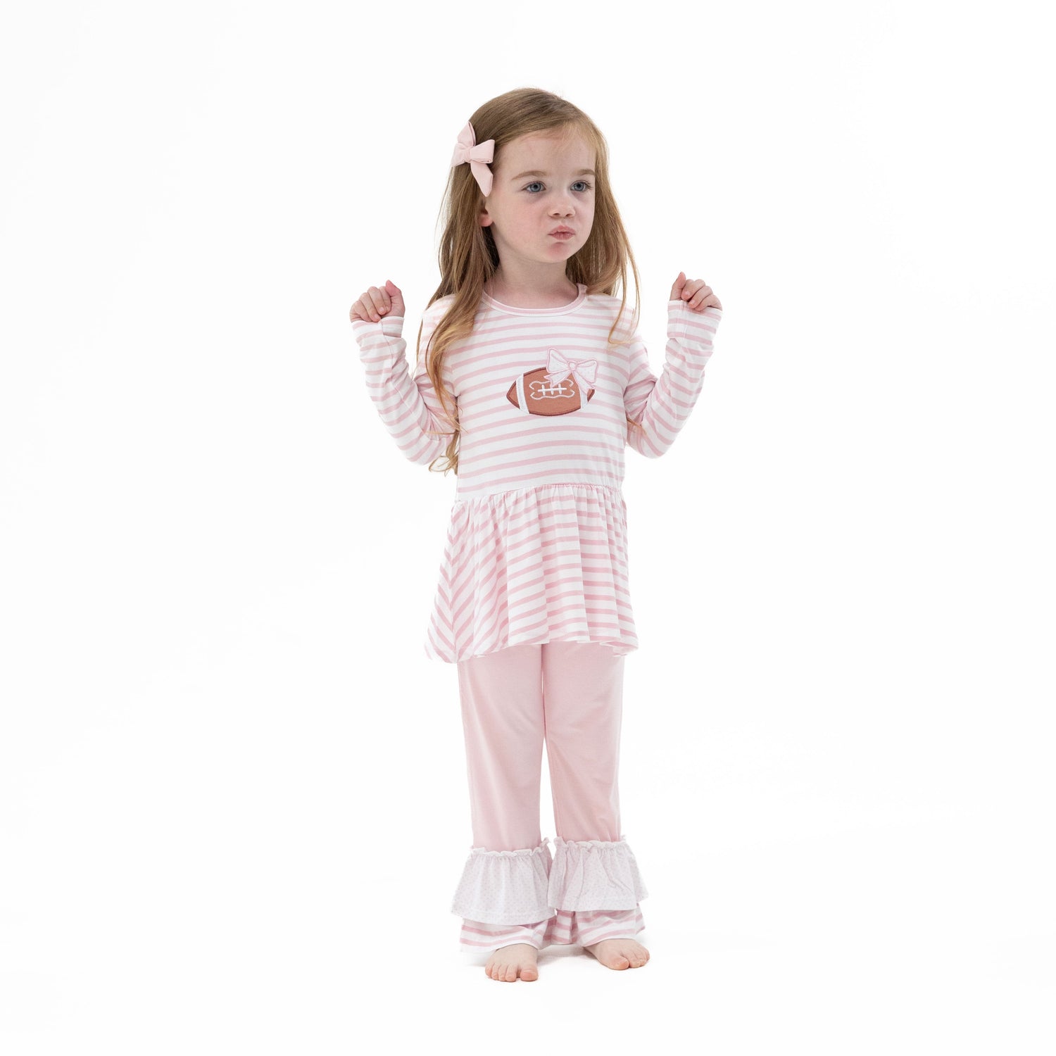 Two-piece set with long sleeve peplum top featuring a football and bow appliqué, paired with polka dot and stripe ruffle bell