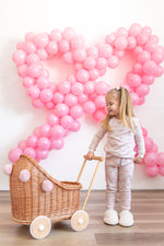 Two-piece baby pajama set in a blushing bows print with top and matching pants