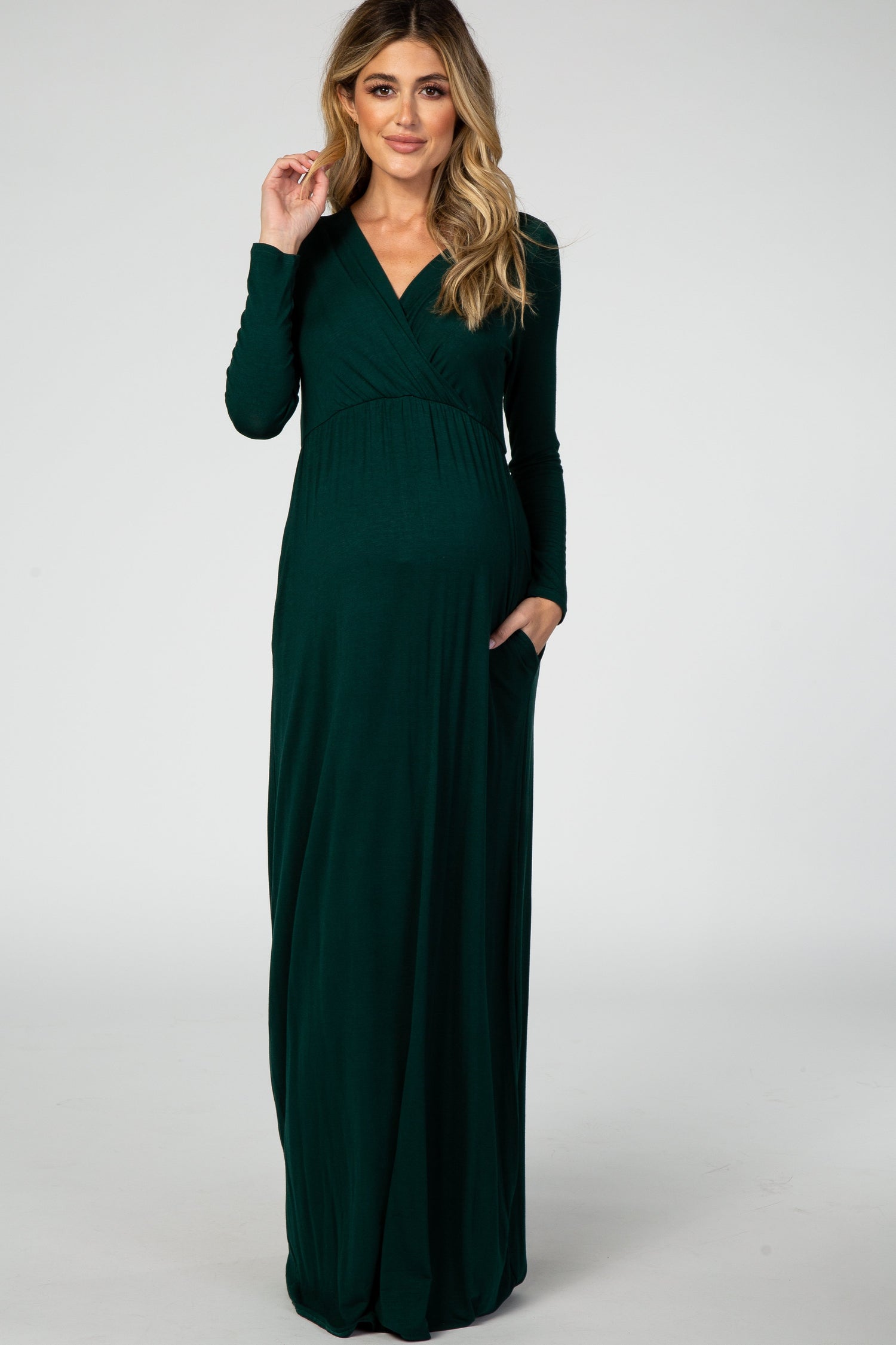 Green long sleeve maternity nursing maxi dress with a flowing floor-length skirt and side pockets