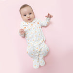 Baby snap footie in orange pumpkin trellis print with white Peter Pan collar and smocked chest detail