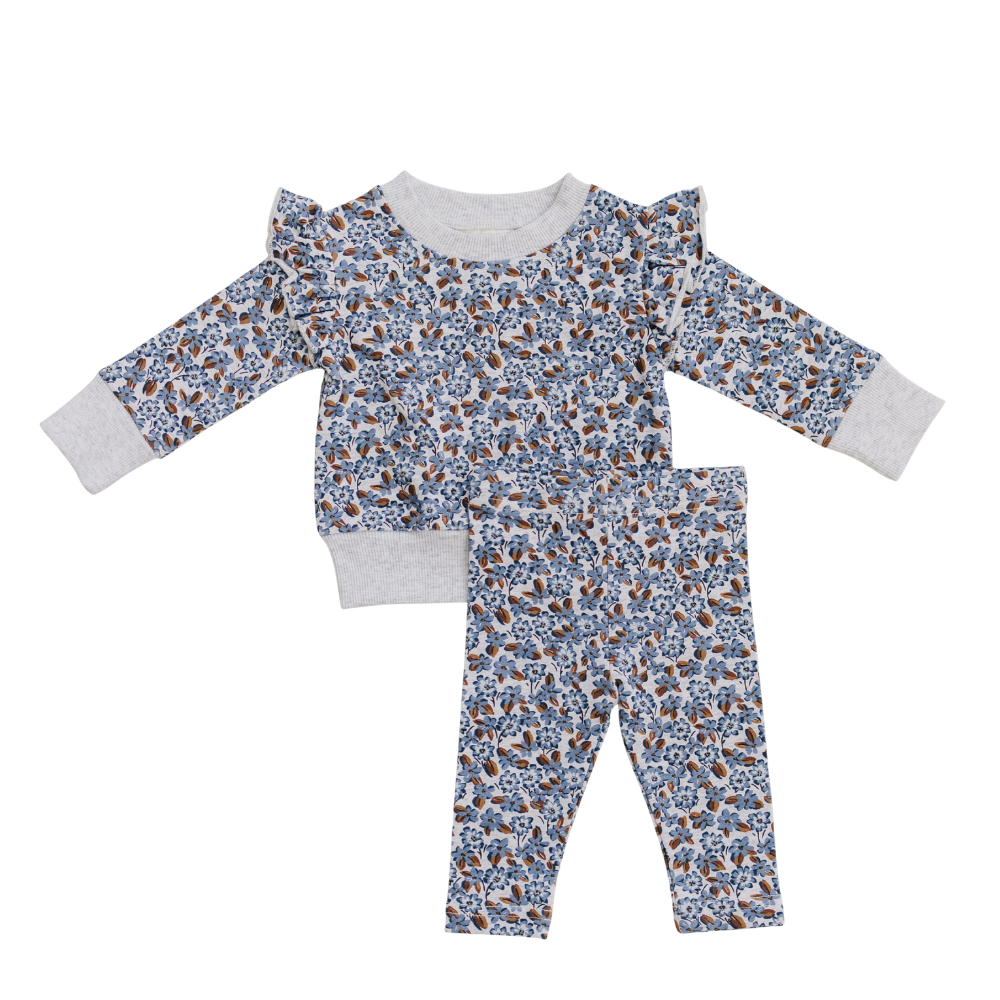 Two-piece baby set in blue floral French terry with a ruffle top and matching pants.