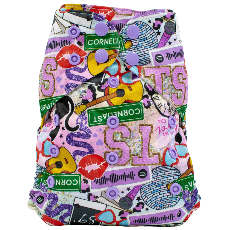 Colorful slim fit pocket cloth diaper with vibrant print and purple snaps.