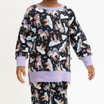 Toddler crew neck sweatshirt in a dark magical unicorn print.
