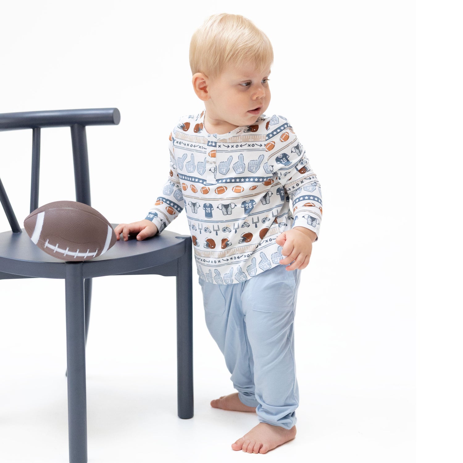 Football stripe long sleeve henley top with wooden button placket paired with matching jogger pants.