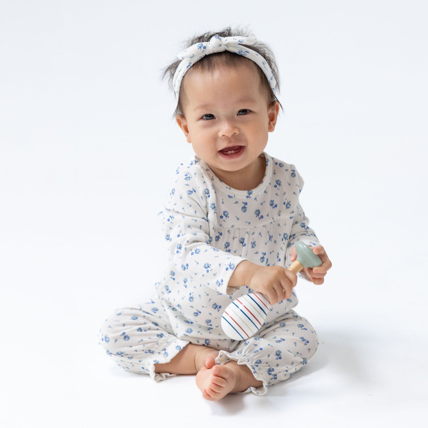 Cuffed sleeve baby romper in Joli Rosette floral print with cuffed legs and snap closures