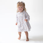 Long sleeve baby dress in floral stripe print with eyelet-trimmed Peter Pan collar, shown with matching bloomer