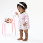 Baby girl's long sleeve smocked bubble romper with attached skirt in a rose stripe print with ruffle trim
