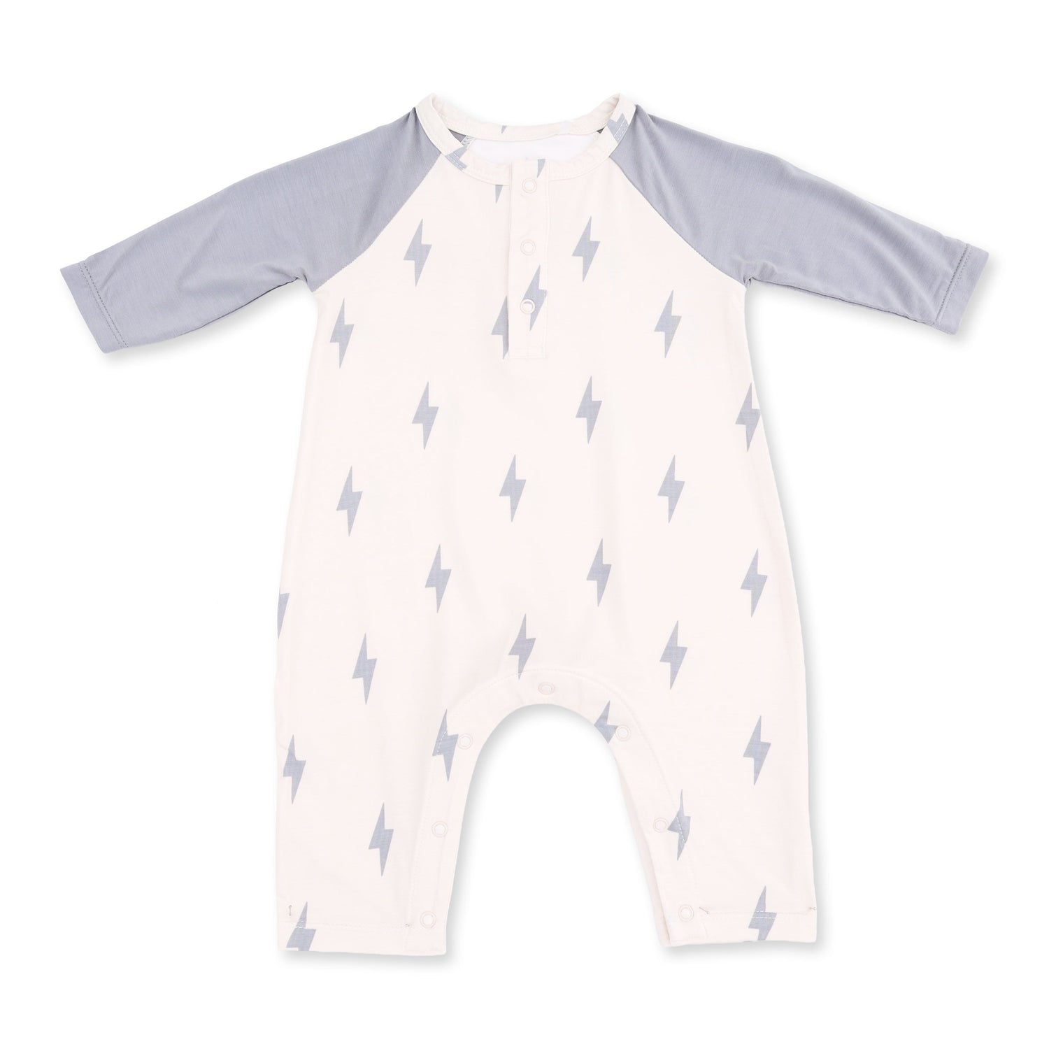 Long sleeve raglan Henley romper with lightning bolt print and a snap-button placket at the chest.
