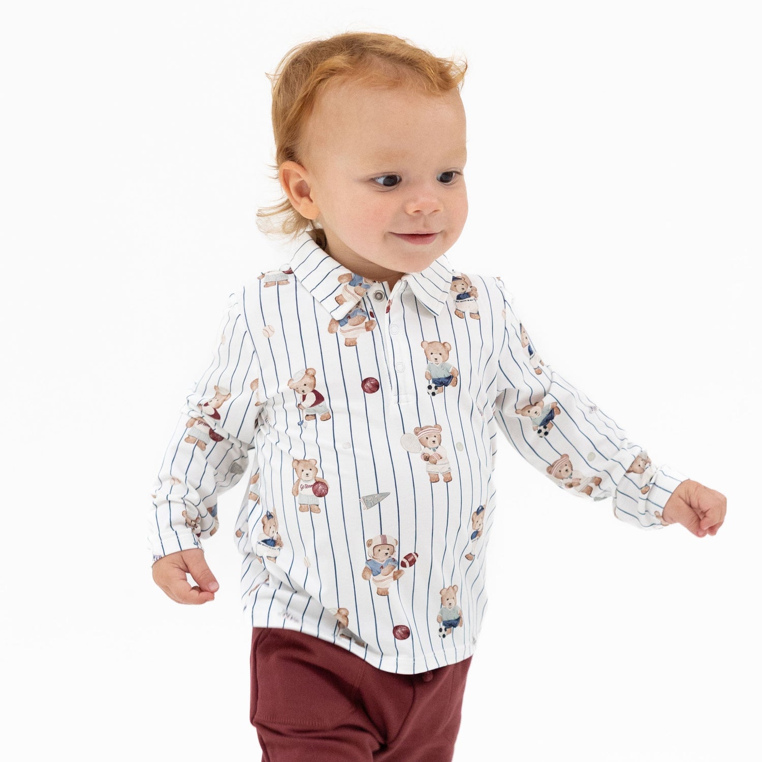 Long sleeve baby polo shirt with a mixed sports bears print, soft collar, and snap button placket