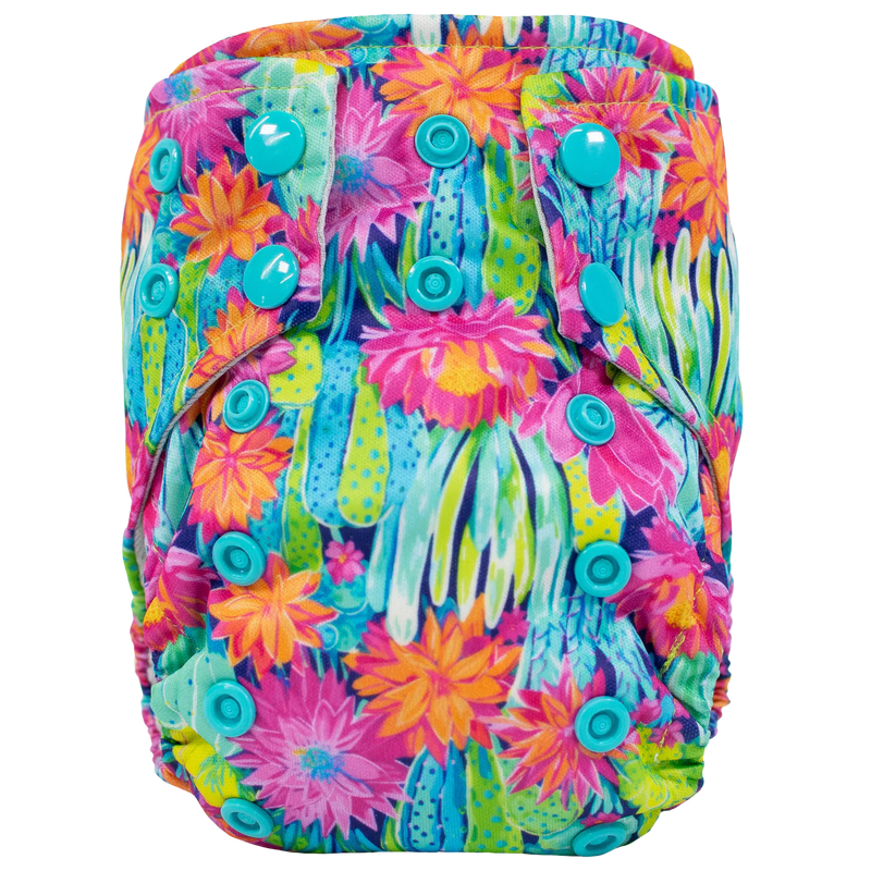 Tiny Tushies Newborn AIO Cloth Diaper with colorful floral pattern and adjustable snaps.