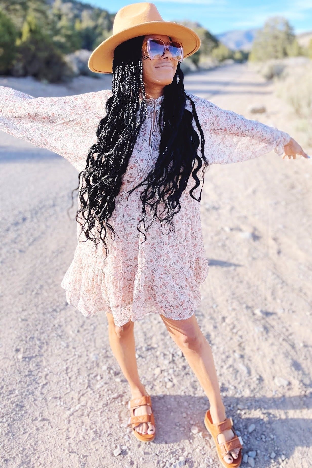 Cream floral chiffon dress with long semi-sheer sleeves, ruffle collar with self-tie straps, and ruffle hem