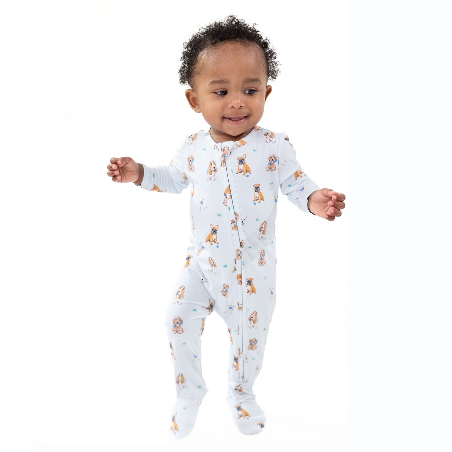 Baby footie with two-way zipper in blue with dog print, fold-over cuffs and footed grippers