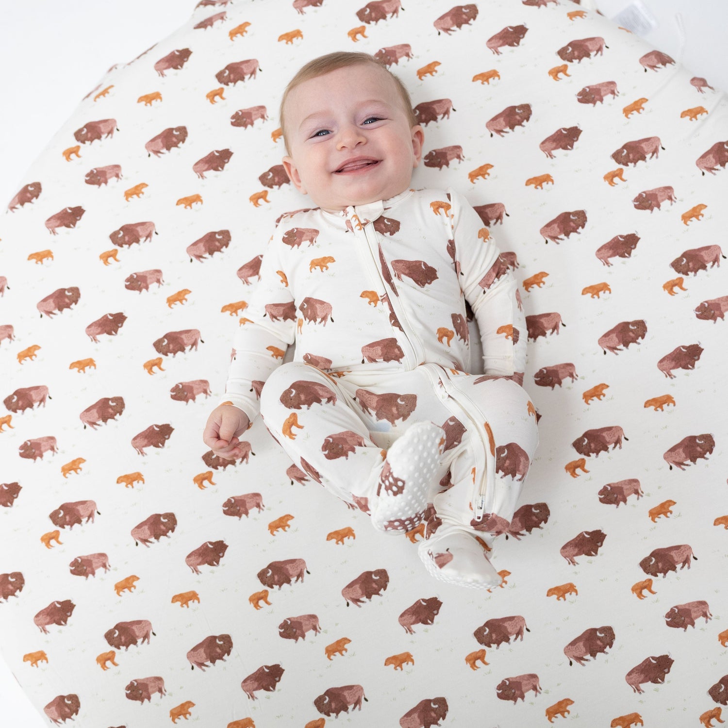 Footie pajamas in an American Buffalo print with a two-way zipper and footed legs