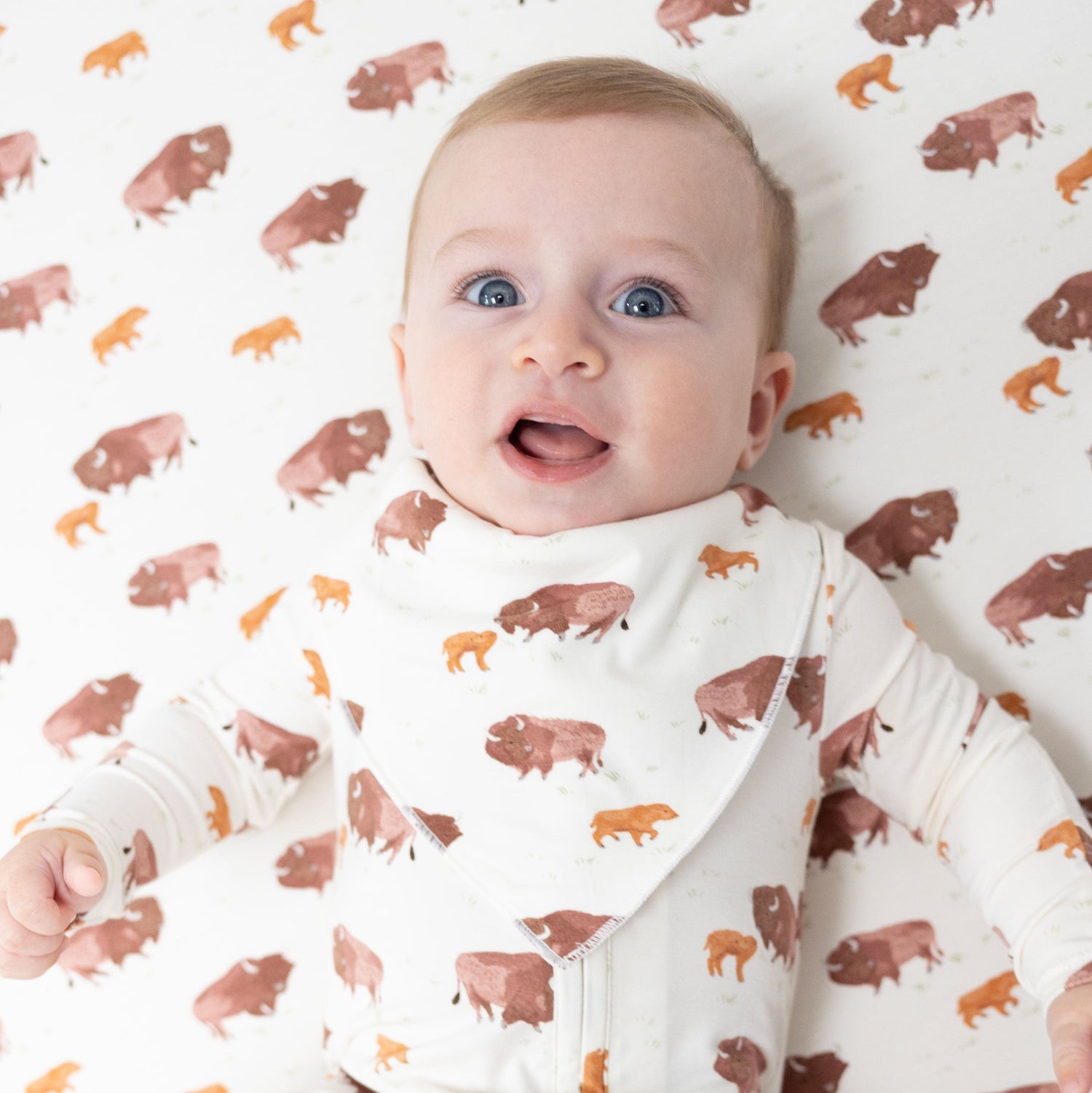 Bandana bib with an American buffalo print and snap closure at the neck