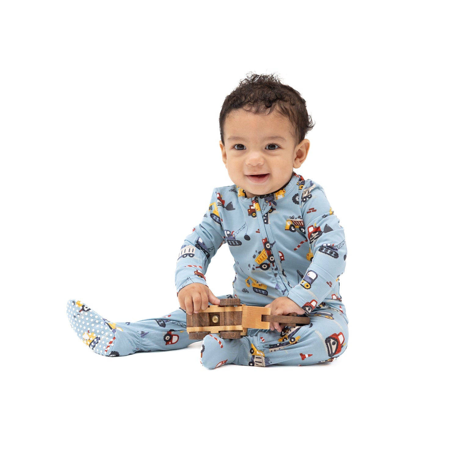 Baby footie pajamas in a crayon-style construction print with a full-length front zipper and footed legs.