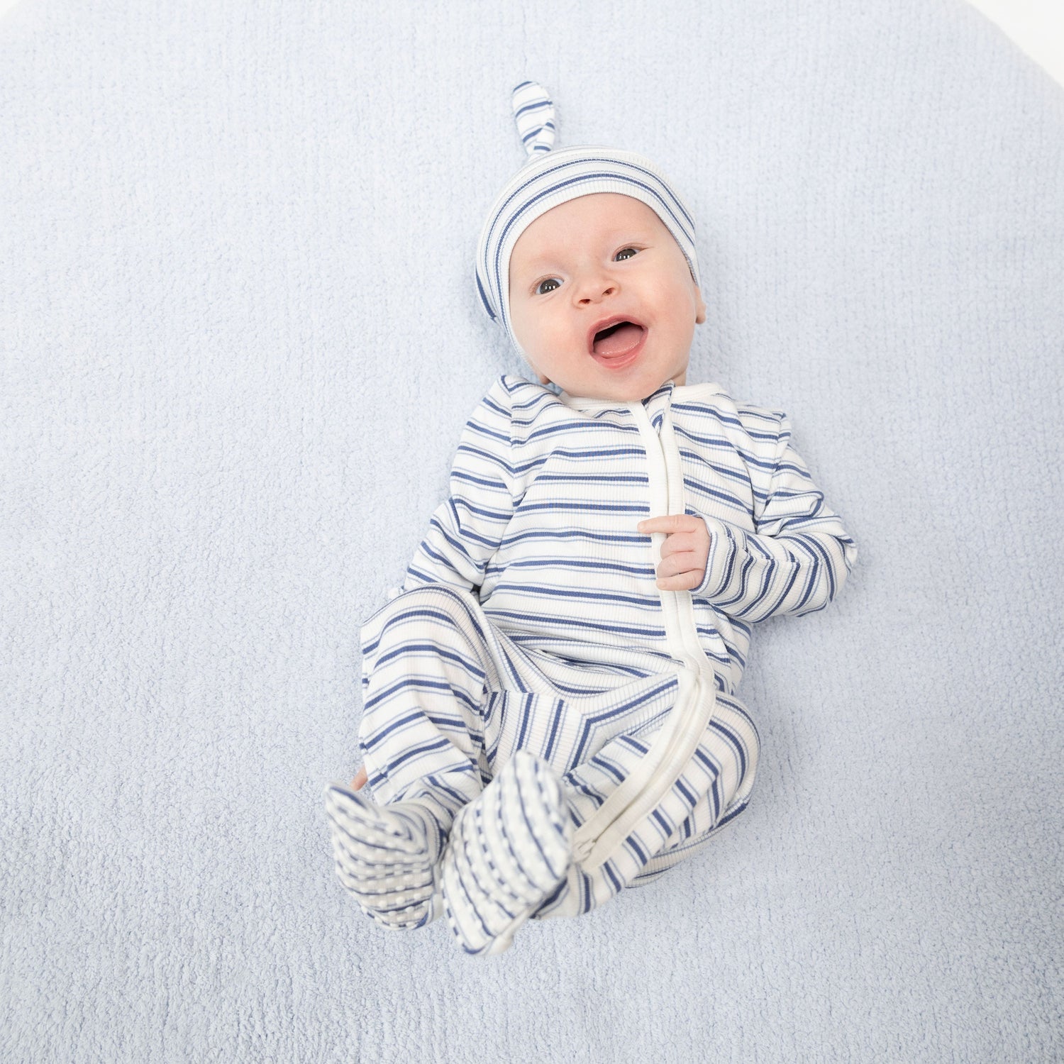 Baby footie pajama in a blue vintage stripe with two-way zipper and footed grippers.