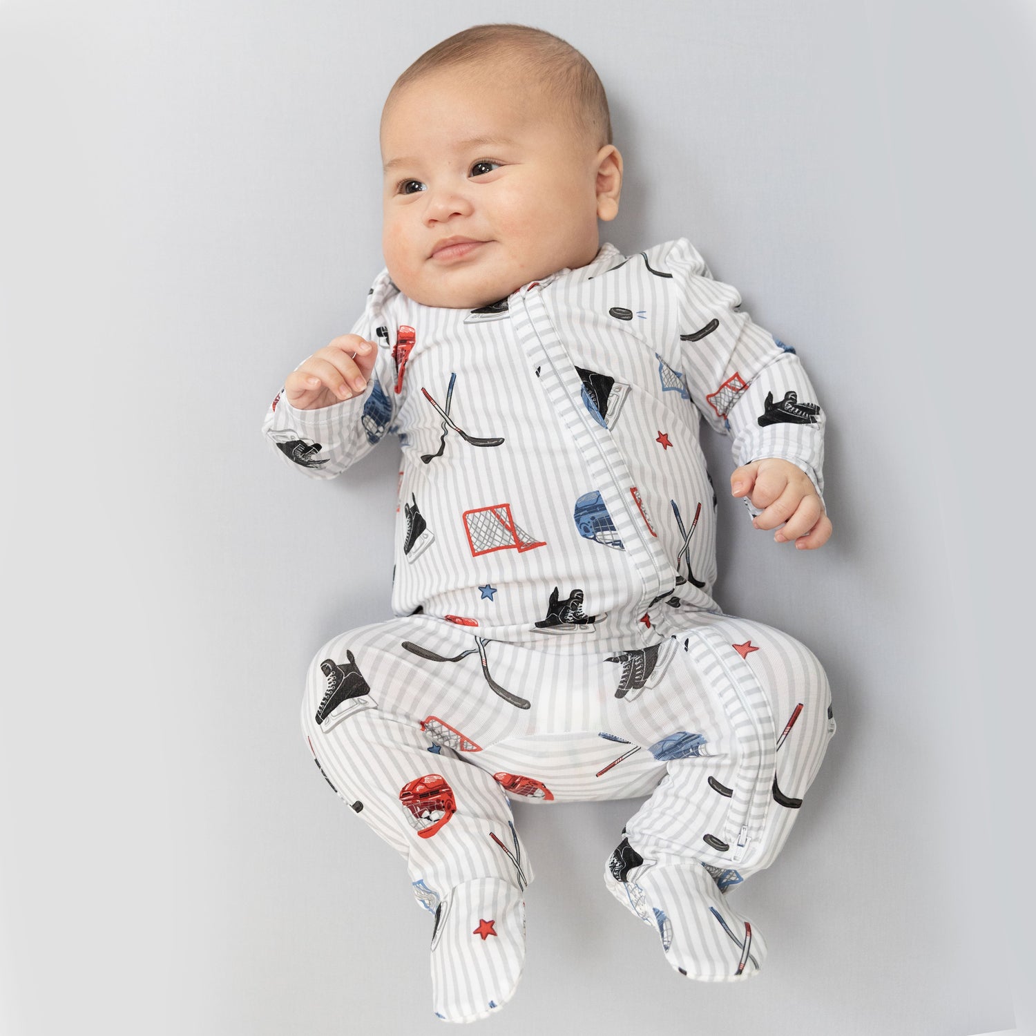 Baby footie pajamas in a hockey-inspired stripe print with two-way zipper, fold-over cuffs, and footed grippers.