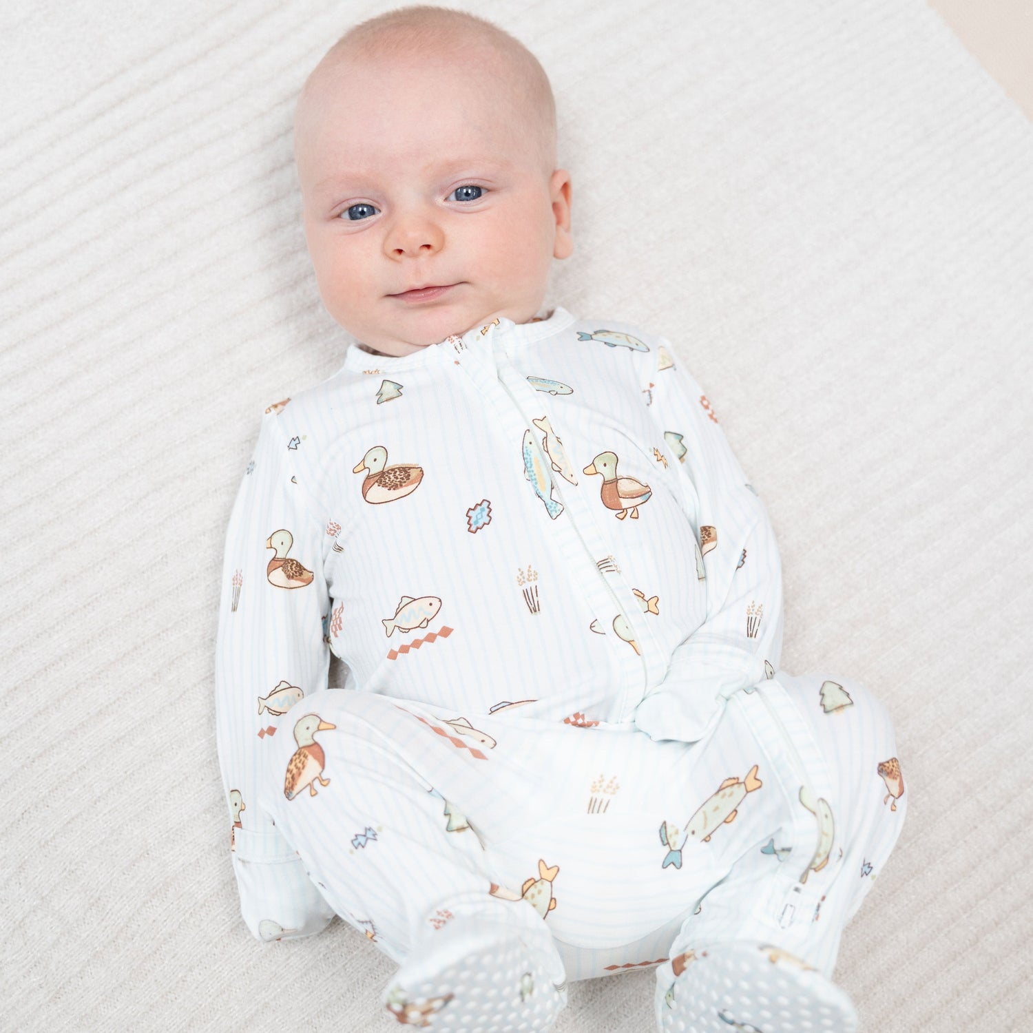 Footie pajamas in a Lake Cuties print with a two-way zipper and fold-over cuffs.