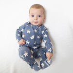 Baby footie pajamas in a sports all-stars print that glows in the dark, with a two-way front zipper and footed legs.