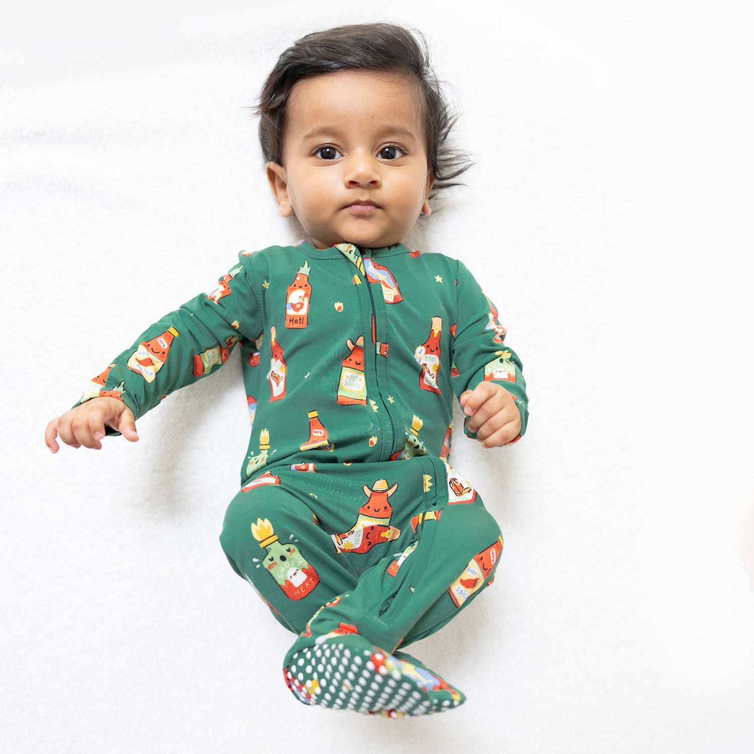 Baby footie with two-way zipper and gripper feet in a spice-jar-inspired print