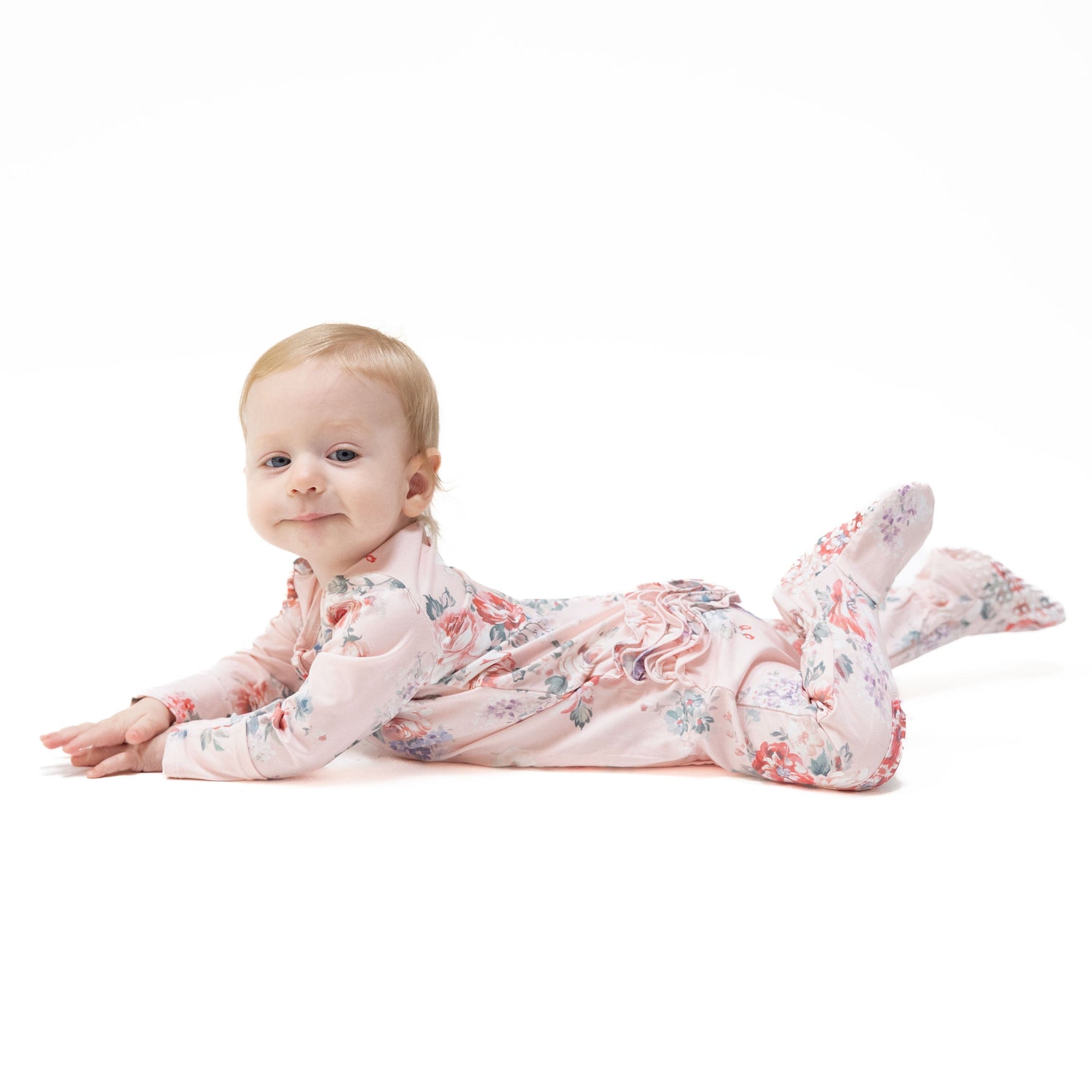 Baby footie in a painterly rose bouquet print with ruffle back detail and full-length zipper.