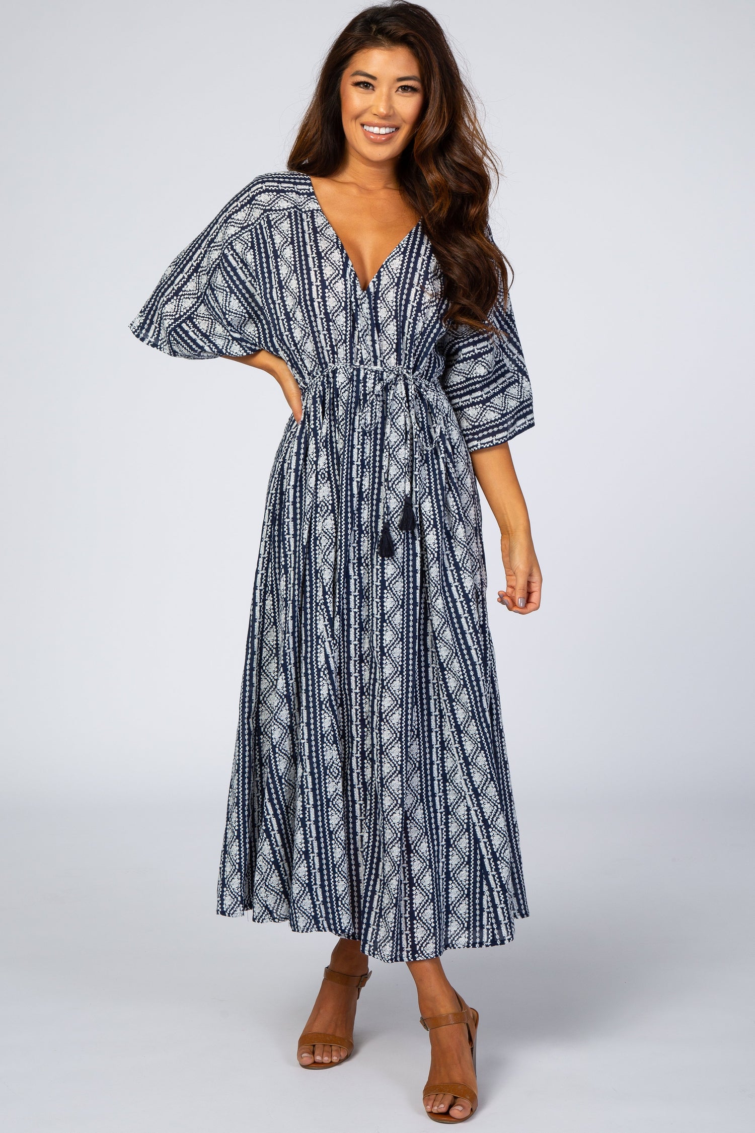 Navy geometric printed midi dress with a V-neckline, wide flowy sleeves, and a drawstring waist.