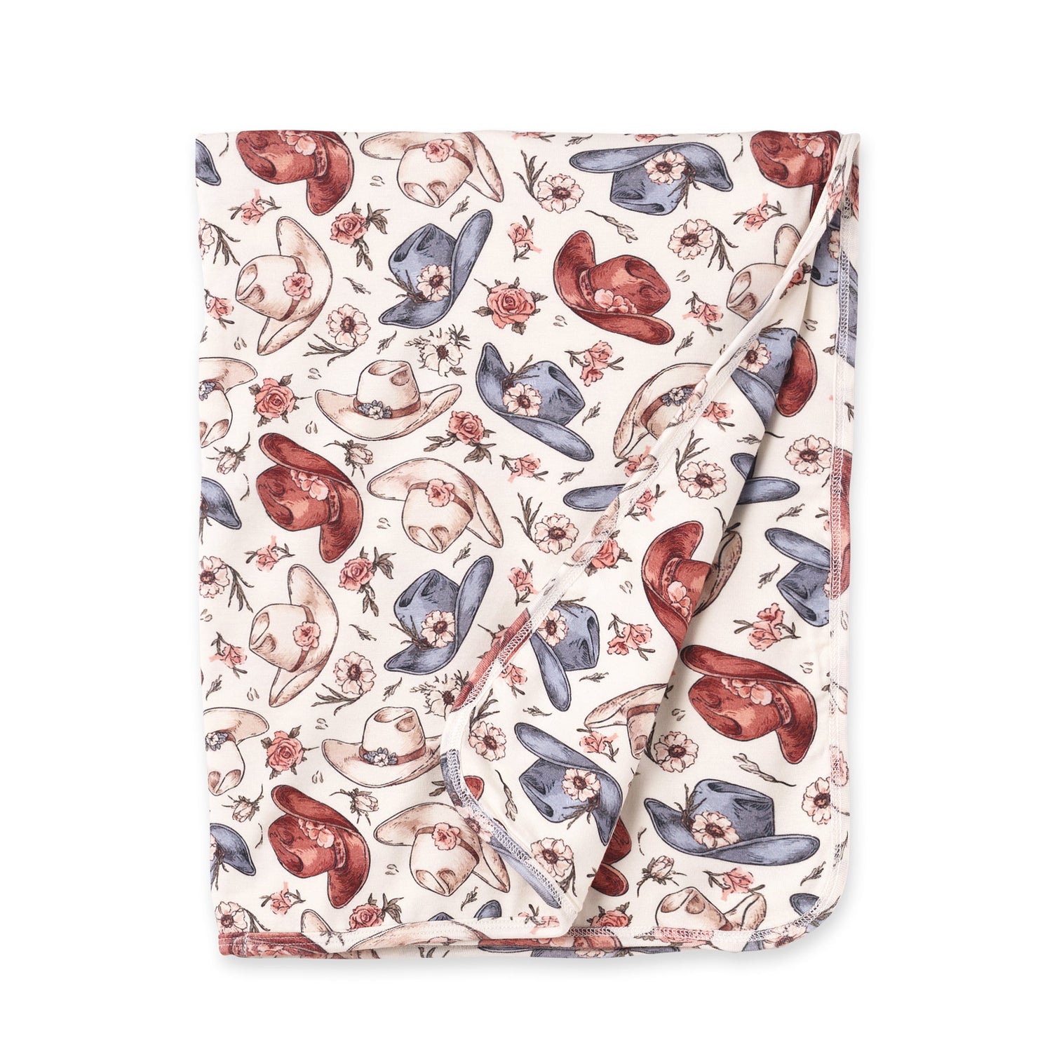 Stroller blanket with a Western print of cowboy hats and wildflower blooms in soft colors.