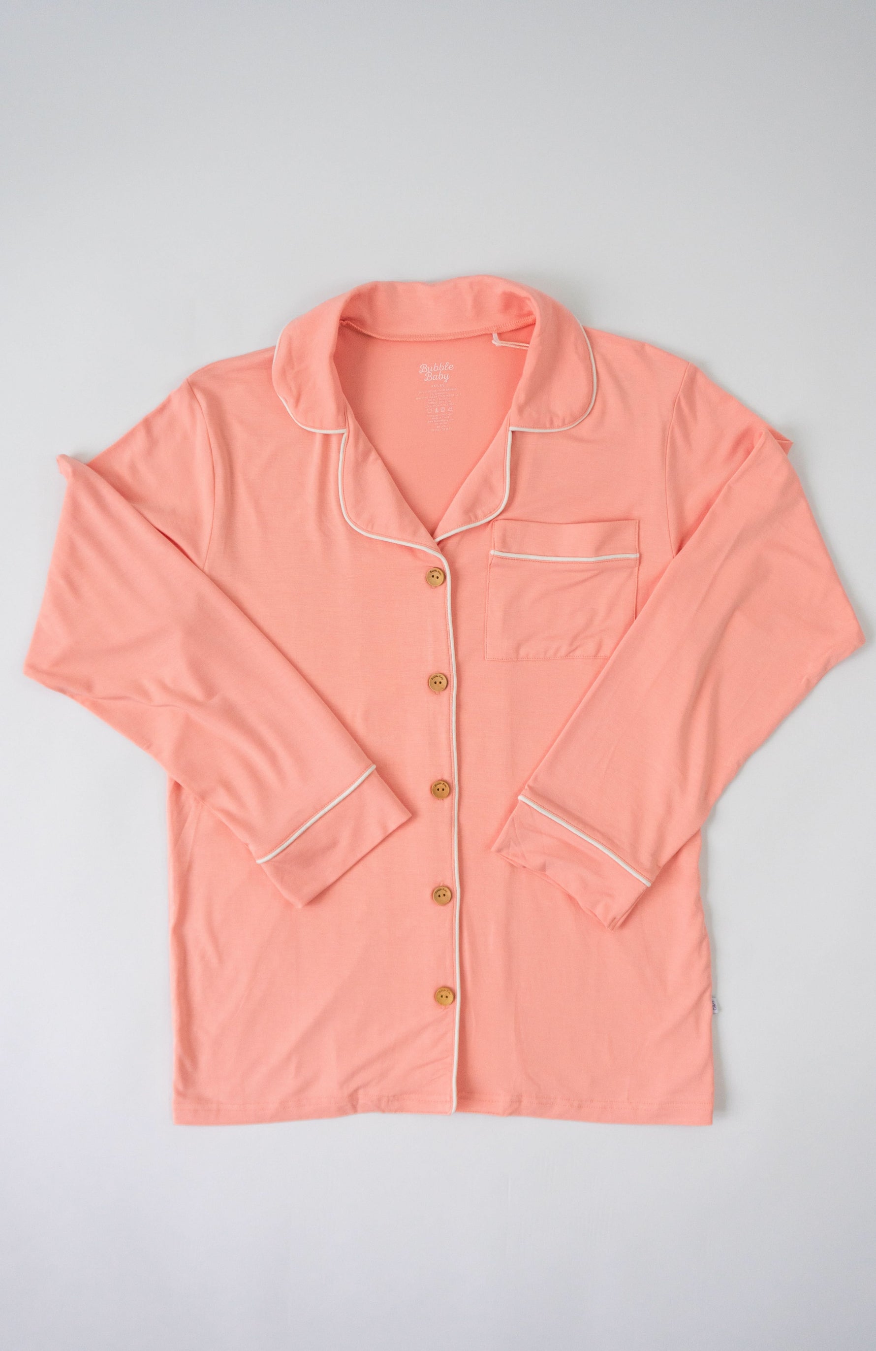 Peach button-up pajama top with collar and long sleeves in a soft warm pink tone