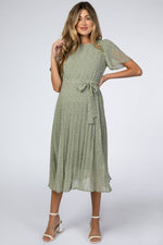 Light olive leaf print maternity midi dress with a pleated skirt worn with heels