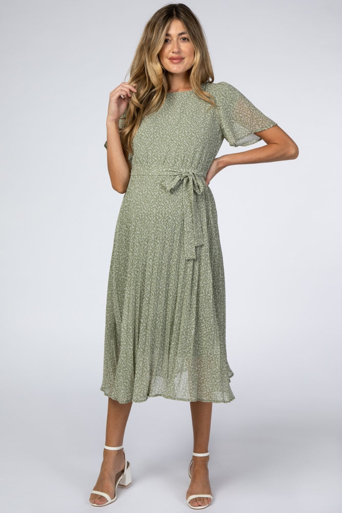 Light olive leaf print maternity midi dress with a pleated skirt worn with heels