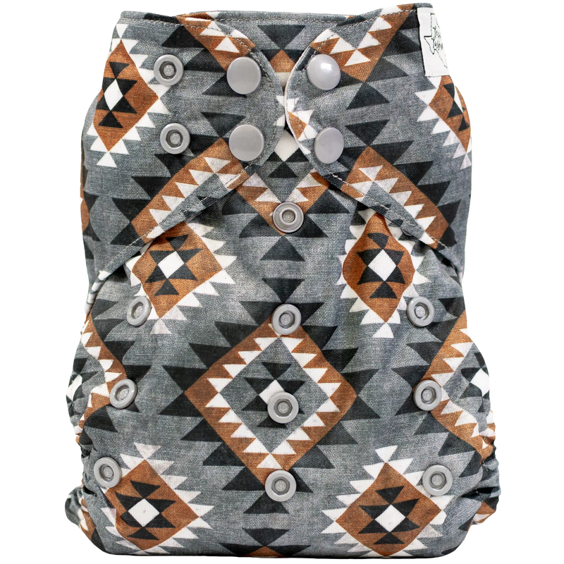 Slim fit pocket cloth diaper with geometric pattern and adjustable snaps.