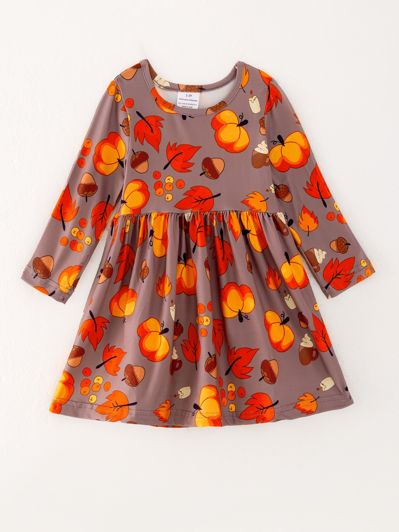 Girls dress with a striped autumn leaves and pine cone print in fall colors