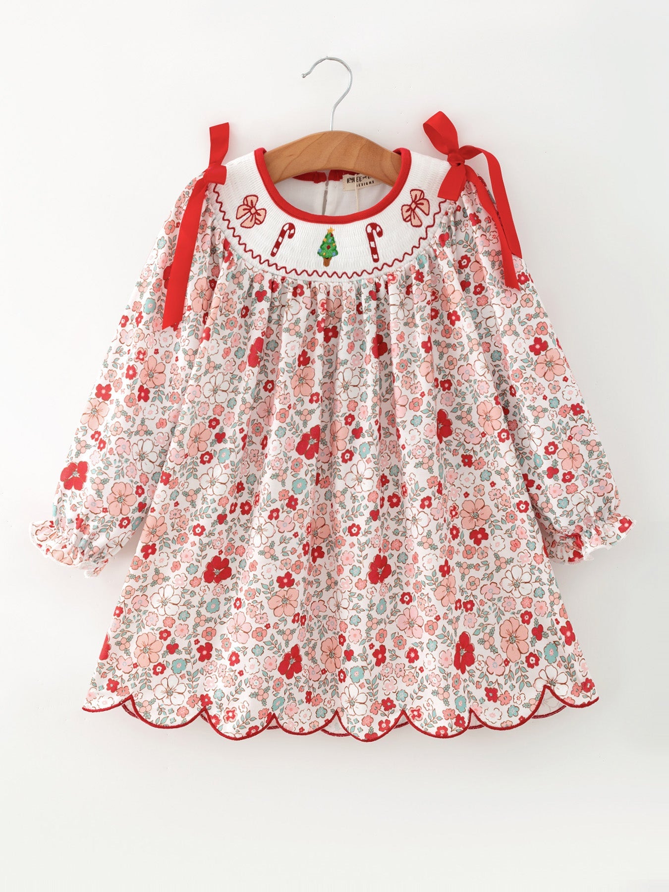 Girls' cream dress with red floral print, candy cane and bow neckline embroidery, red ribbon shoulder bows, scalloped hem