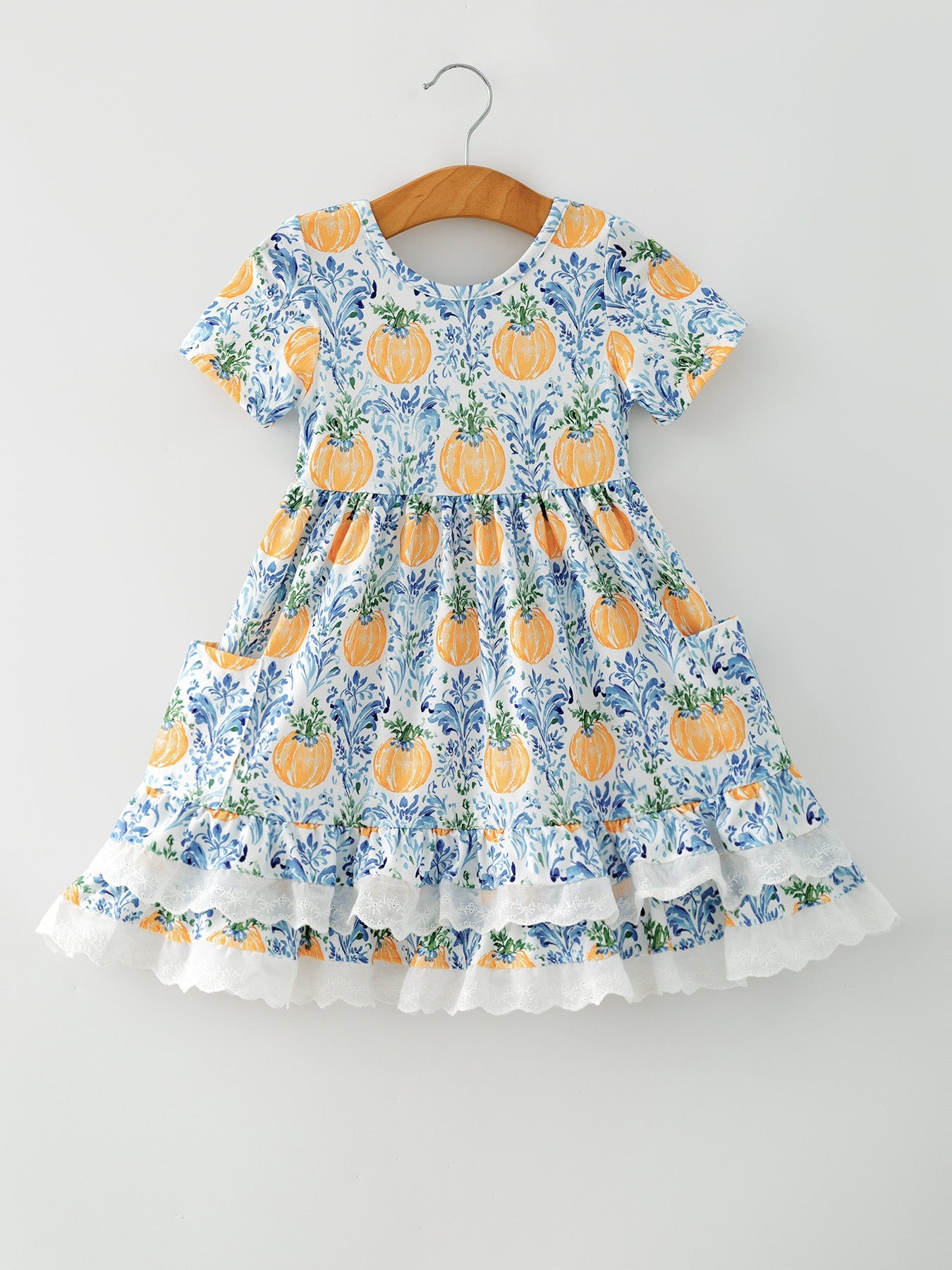Girls fall dress with pumpkin print, lace trim along the hem, and side pockets