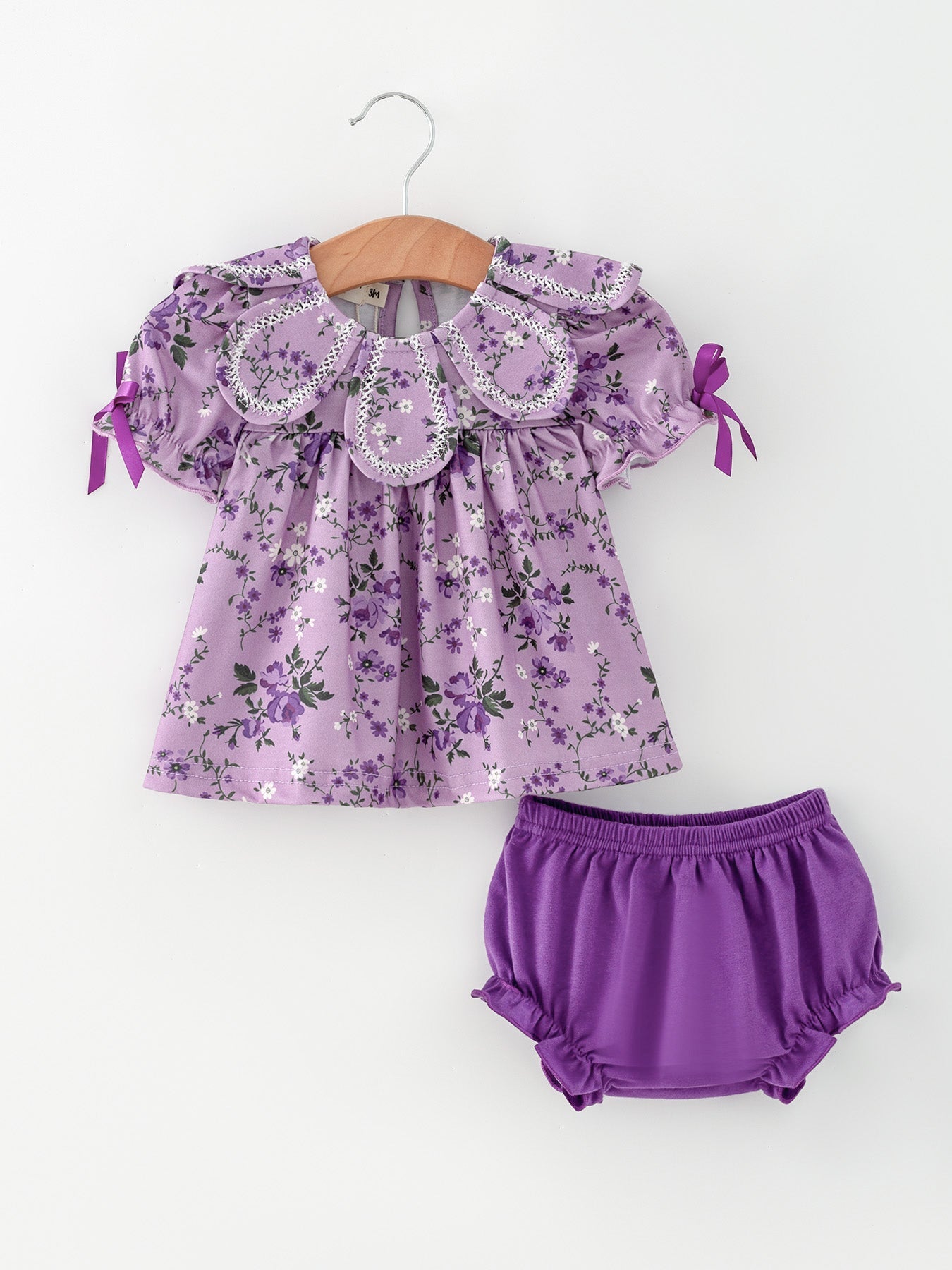 Purple floral puff-sleeve top with petal-style collar and matching solid purple bloomers set for girls.