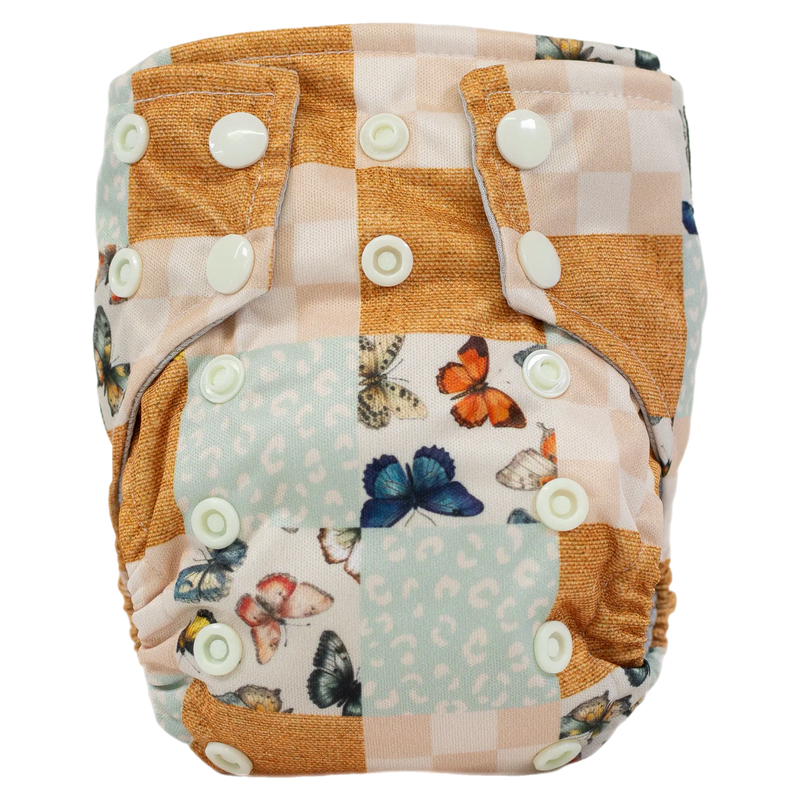 Tiny Tushies Newborn AIO Cloth Diaper with butterfly print and snaps.