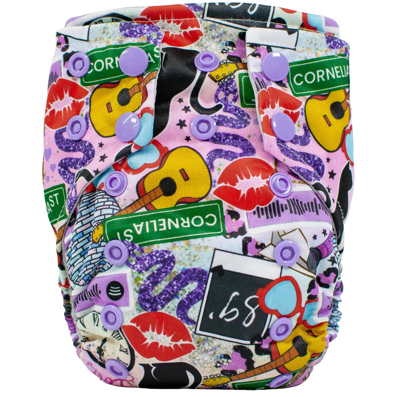 Tiny Tushies Newborn AIO cloth diaper with colorful printed design and snaps.