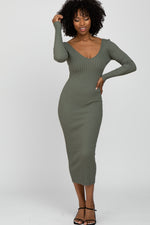 Light olive fitted maxi dress with a v-neckline and long sleeves, worn with heeled sandals.