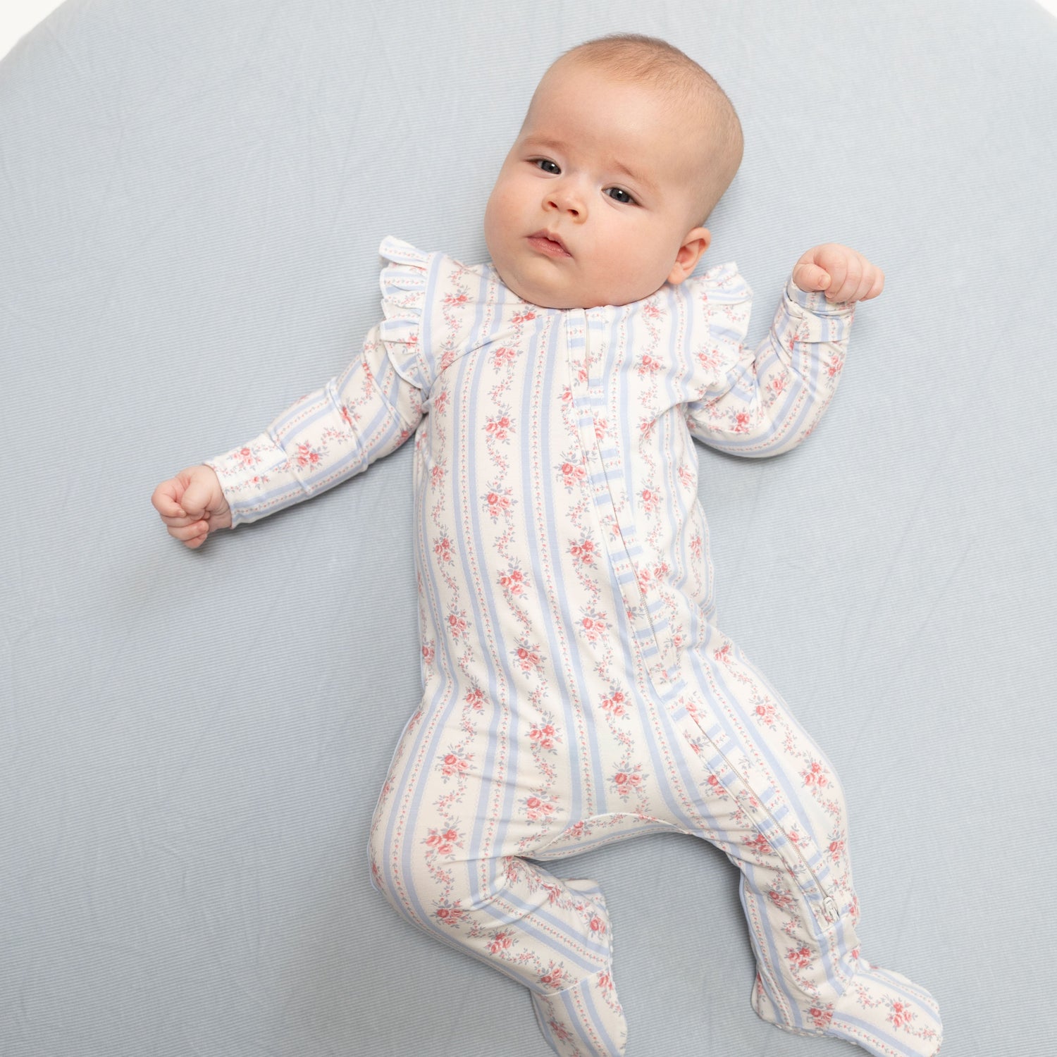 Baby footie pajamas in Anna floral stripe print with ruffle sleeves, fold-over cuffs, and a full-length zipper with footed
