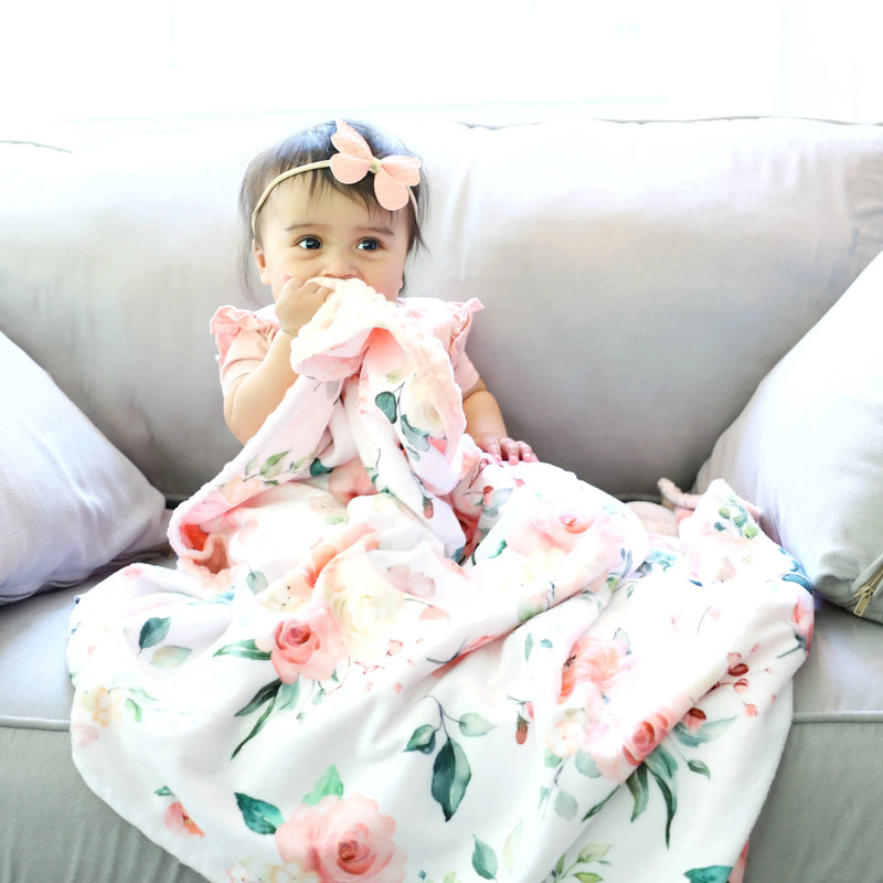Premium baby and toddler blanket in peach floral design on a soft, lightweight fabric with minky dot texture.