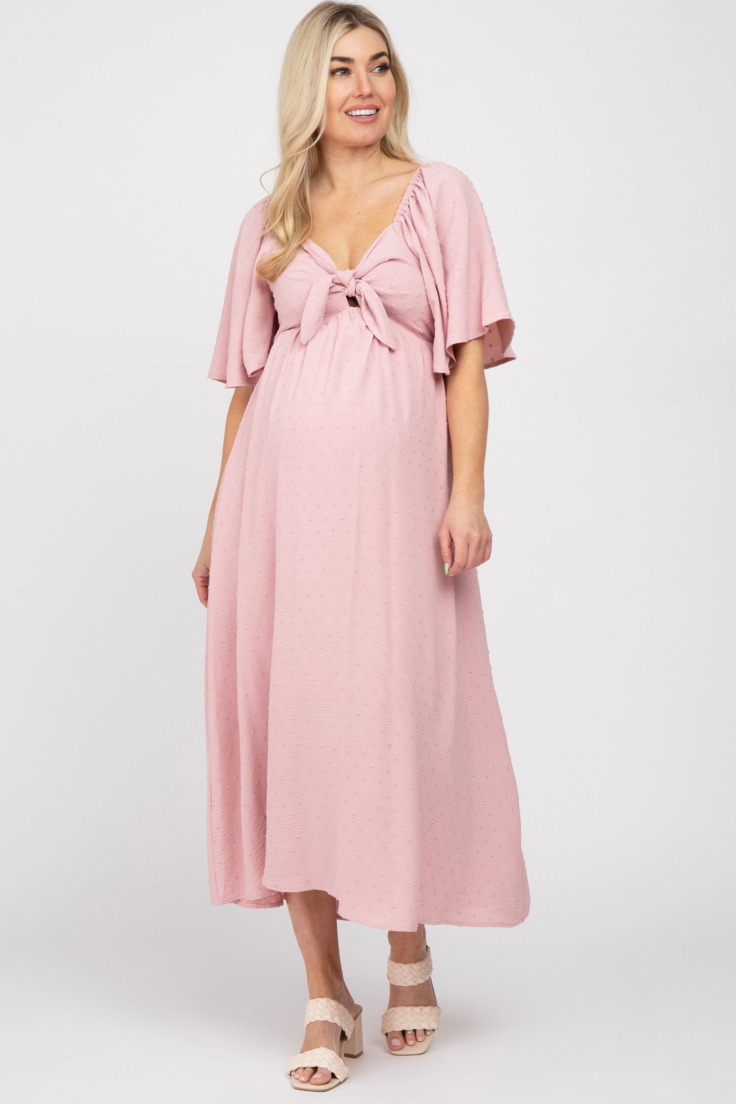 Mauve textured dot maternity midi dress with front tie, cutout, and short ruffle sleeves.