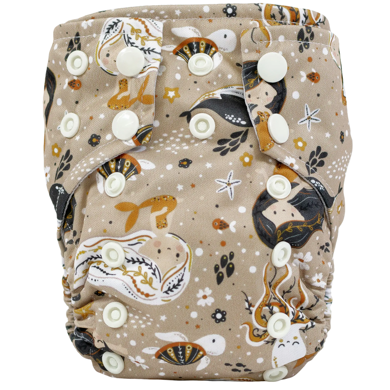Tiny Tushies Newborn AIO Cloth Diaper with whimsical printed design and snap closures.