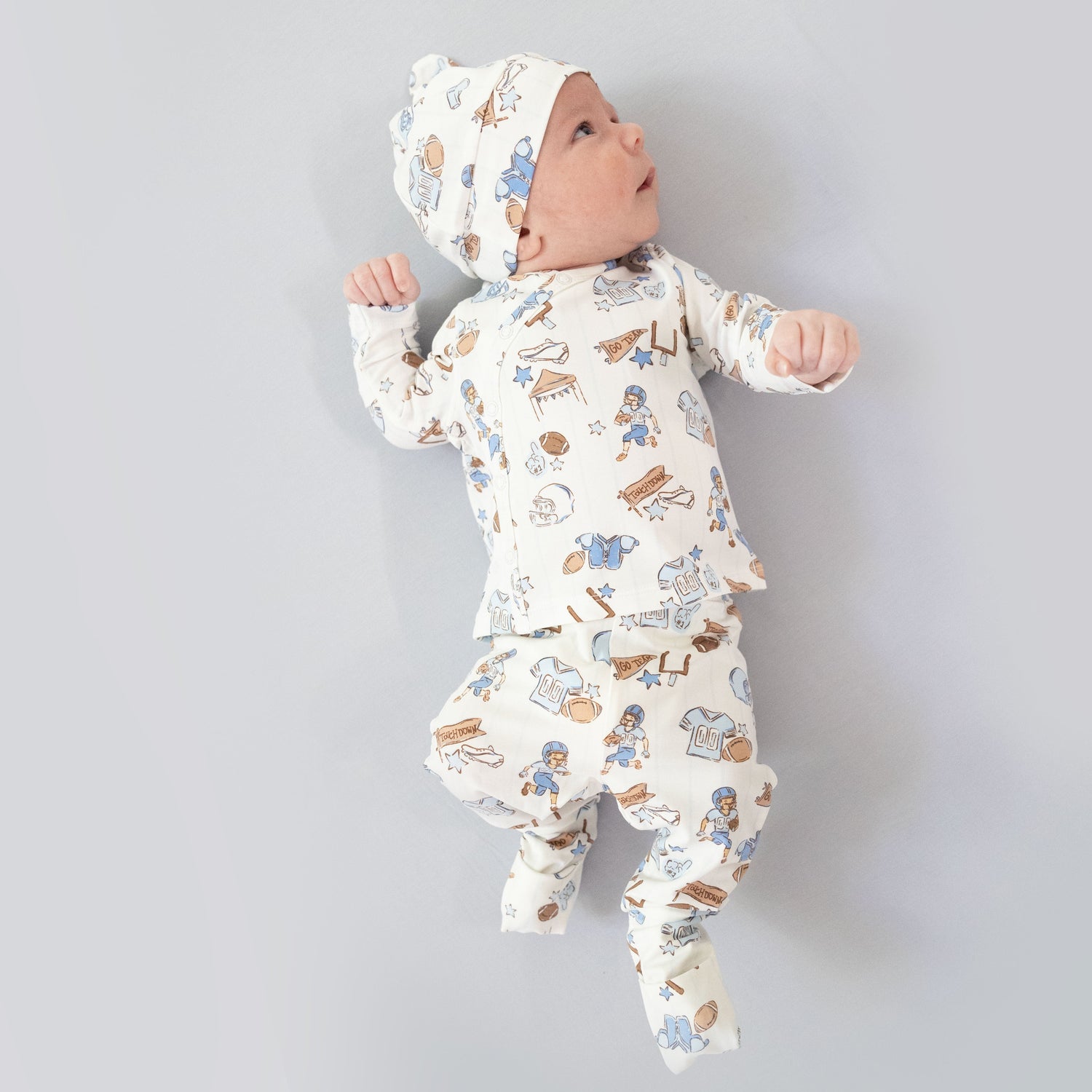 Take-me-home set with football-print pants, matching beanie hat, and coordinating swaddle blanket
