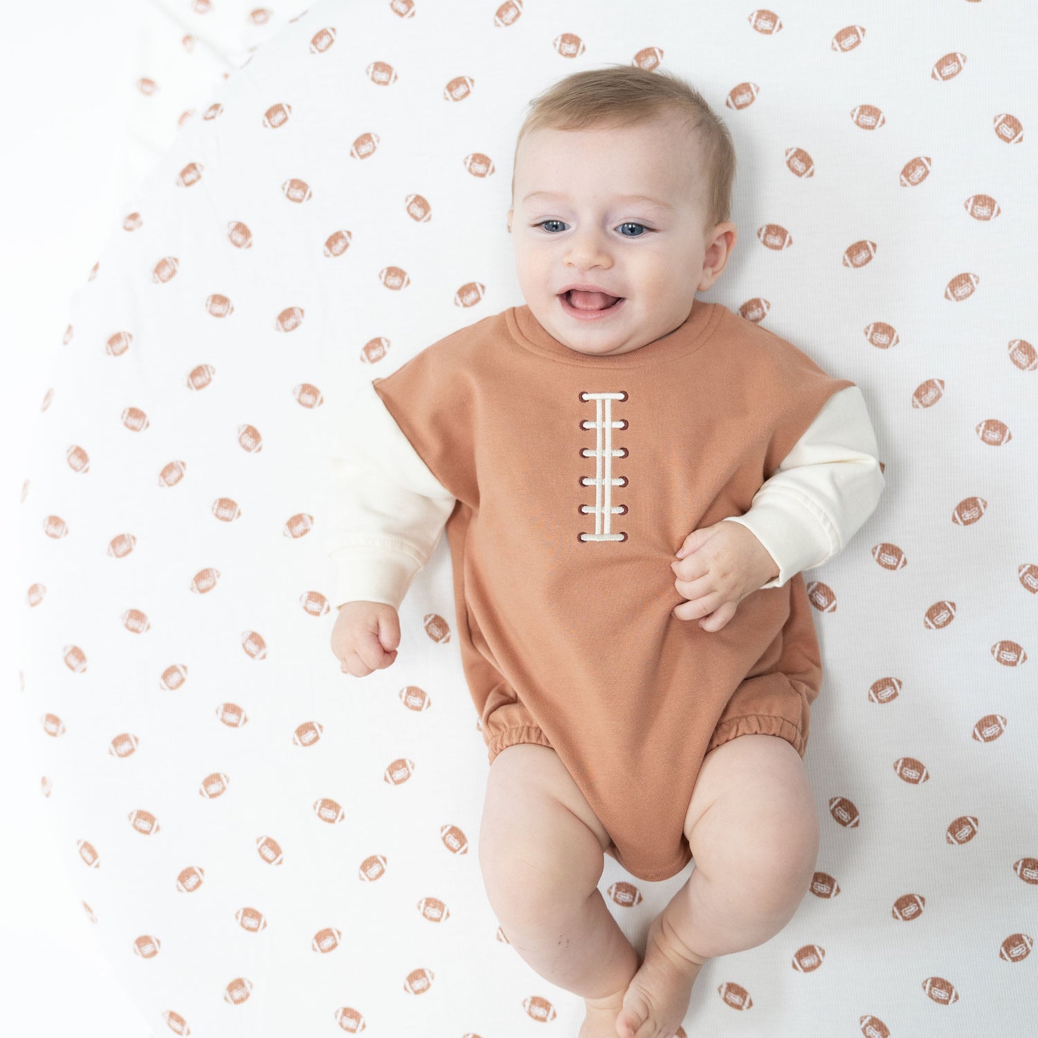 Baby sweatshirt bubble one-piece in gray French terry with football laces embroidery on the front.