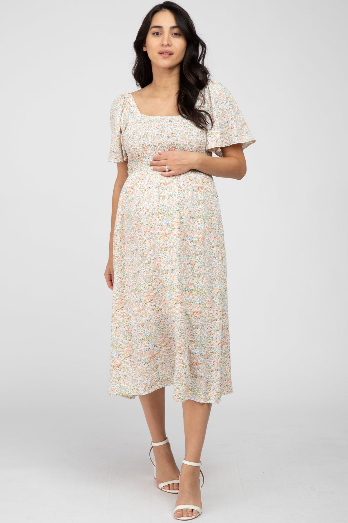 Cream floral maternity midi dress with square neckline, smocked top and short flutter sleeves.